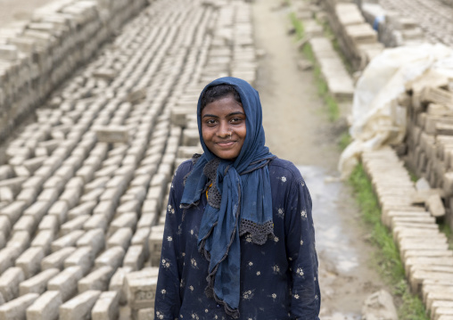 Portrait of a smiling bangladeshi female worker in a brick factory, Sylhet Division, Bahubal, Bangladesh