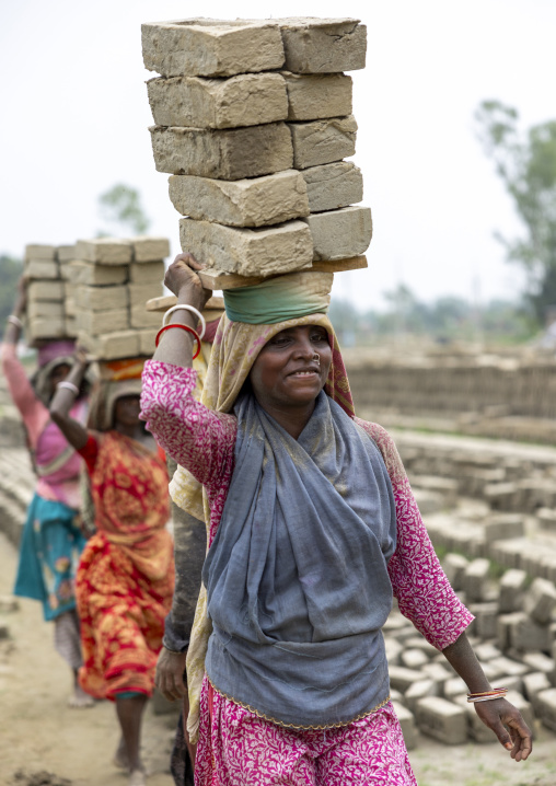 Women carrying bricks on their heads at a brick factory, Sylhet Division, Bahubal, Bangladesh