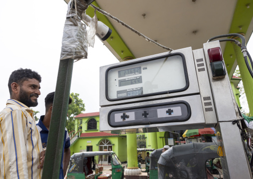 A car is fueled with compressed natural gas at a pump station, Chittagong Division, Ashuganj, Bangladesh