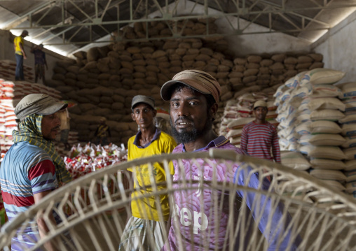 Bangladeshi men working in a rice warehouse, Chittagong Division, Ashuganj, Bangladesh