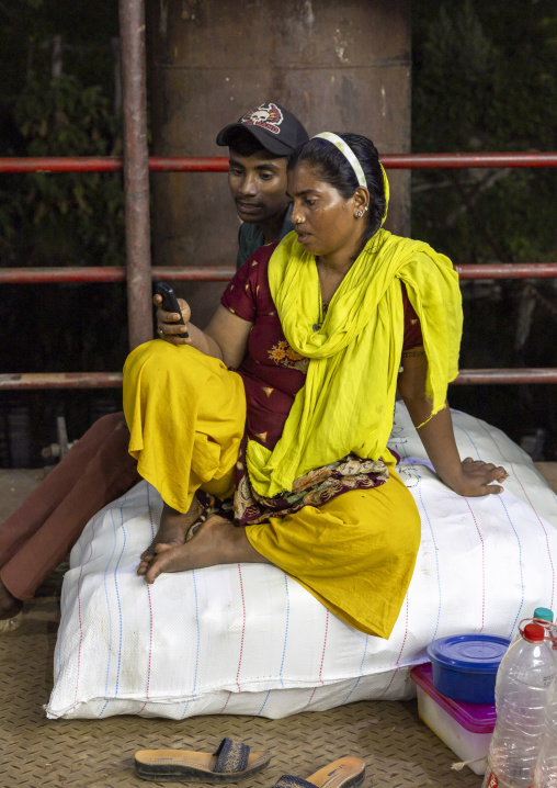 Bangladeshi couple waiting boat at Sadaghat Launch Terminal, Dhaka Division, Dhaka, Bangladesh