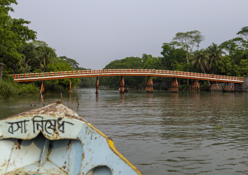 Boat on a river with a bridge in Sundarbans, Barisal Division, Banaripara, Bangladesh