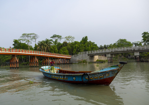 Bangladeshi man on a local boat on a river, Barisal Division, Banaripara, Bangladesh