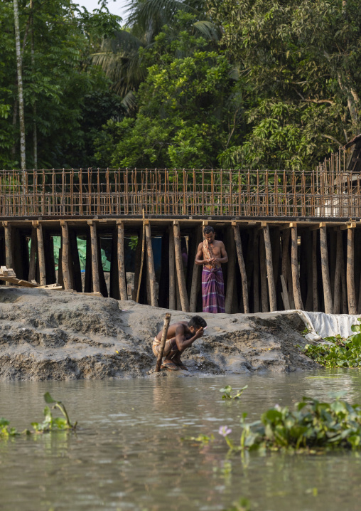 Bangladeshi men washing in the river in Sundarbans, Barisal Division, Banaripara, Bangladesh