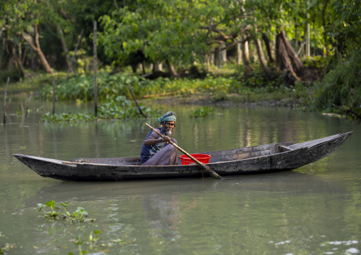 Old man on a local boat on a river, Barisal Division, Banaripara, Bangladesh