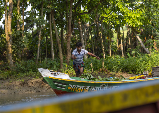 Bangladeshi man on a local boat on a river, Barisal Division, Banaripara, Bangladesh