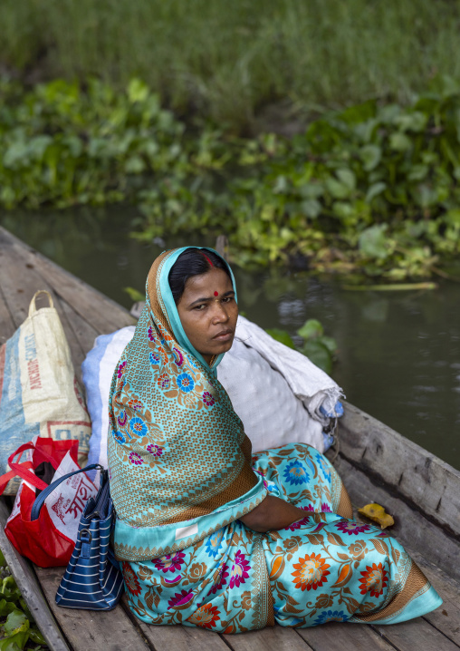 Portrait of a veiled woman in a boat, Barisal Division, Banaripara, Bangladesh