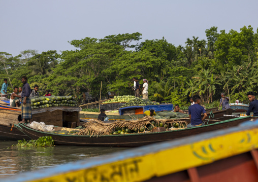 Bangladeshi men selling fruits and vegetables at weekly floating market, Barisal Division, Harta, Bangladesh