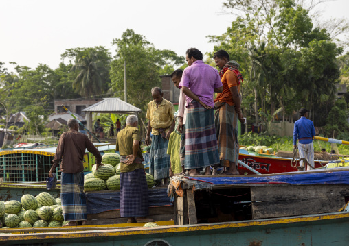 Bangladeshi men selling fruits and vegetables at weekly floating market, Barisal Division, Harta, Bangladesh