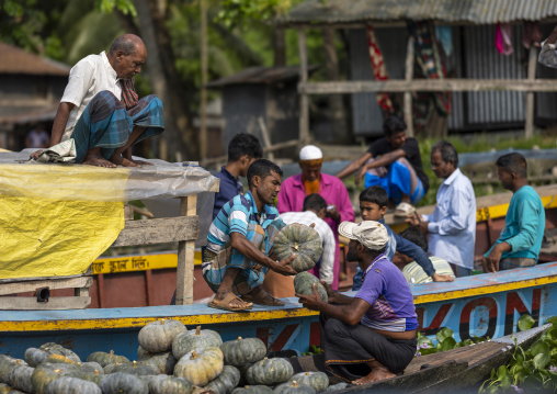 Bangladeshi men selling fruits and vegetables at weekly floating market, Barisal Division, Harta, Bangladesh