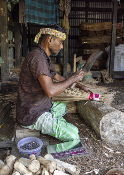 Bangladeshi man making a broom in his workshop in Sundarbans, Barisal Division, Harta, Bangladesh