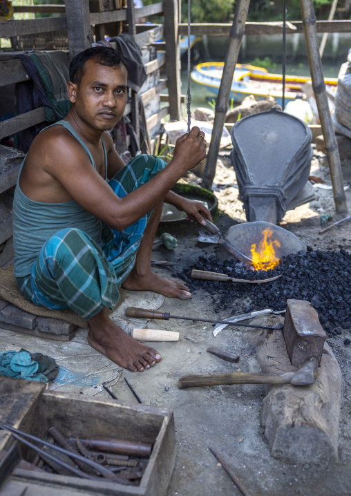 Bangladeshi blacksmith working in Sundarbans, Barisal Division, Harta, Bangladesh