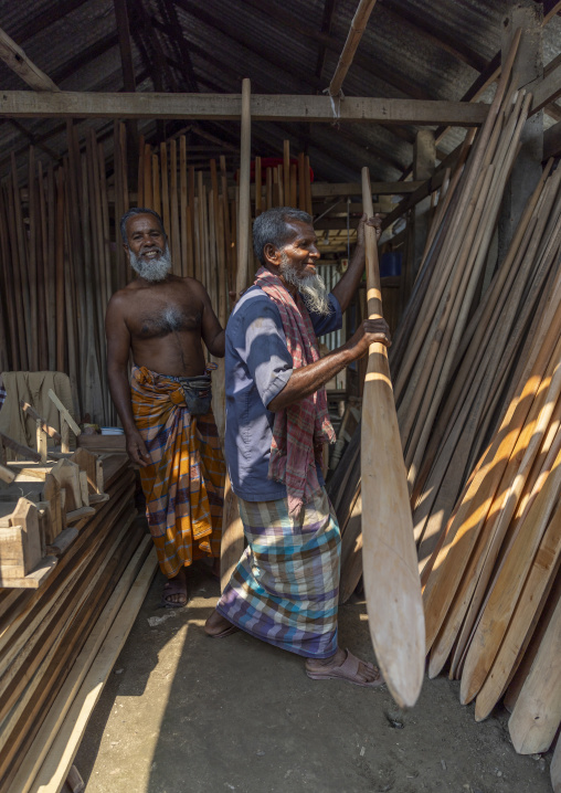 Bangladeshi men selling wooden oars in a shop in Sundarbans, Barisal Division, Harta, Bangladesh