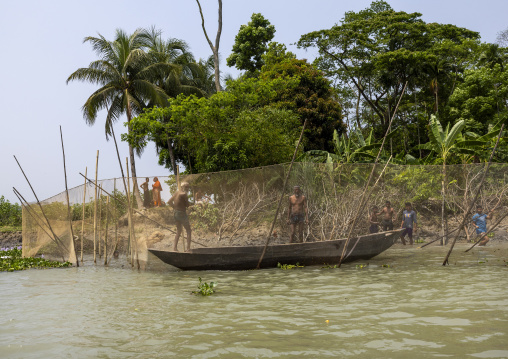 Bangladeshi people catching fish using large lift net on the river, Barisal Division, Wazirpur, Bangladesh