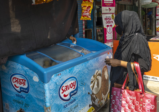 Man selling ice cream hidden behind a curtain during ramadan fast, Khulna Division, Shyamnagar, Bangladesh