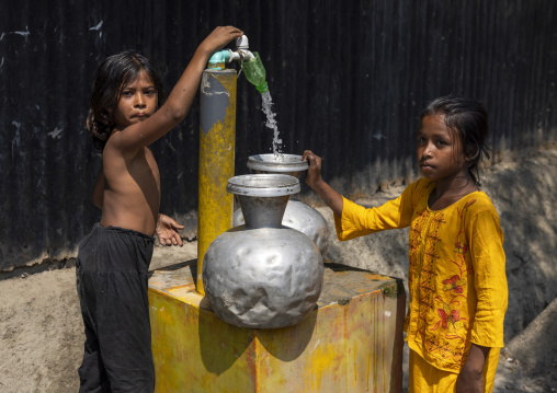 Bangladeshi girls collecting water from pump in Sundarbans, Khulna Division, Shyamnagar, Bangladesh