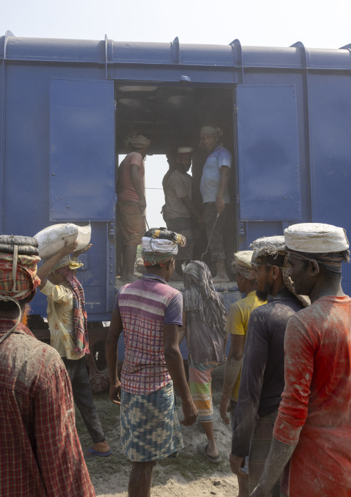 Bangladeshi workers unloading cement bags from a train, Khulna Division, Abhaynagar, Bangladesh