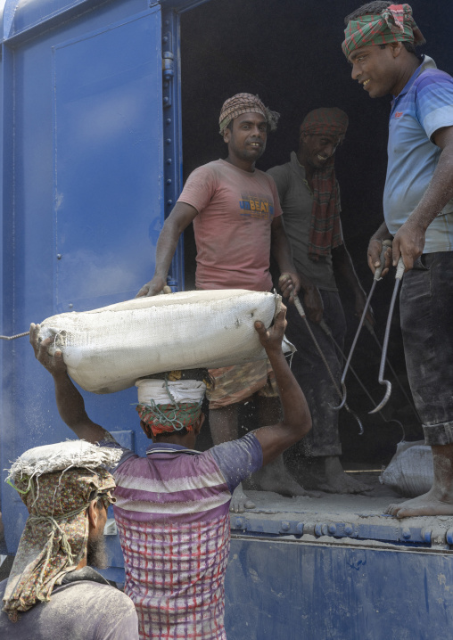 Bangladeshi workers unloading cement bags from a train, Khulna Division, Abhaynagar, Bangladesh