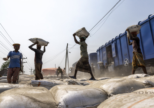 Bangladeshi workers unloading cement bags from a train, Khulna Division, Abhaynagar, Bangladesh