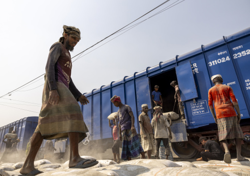 Bangladeshi workers unloading cement bags from a train, Khulna Division, Abhaynagar, Bangladesh