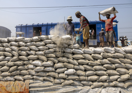 Bangladeshi workers unloading cement bags from a train, Khulna Division, Abhaynagar, Bangladesh