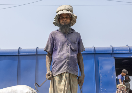 Bangladeshi workers unloading cement bags from a train, Khulna Division, Abhaynagar, Bangladesh