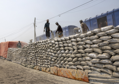 Bangladeshi workers unloading cement bags from a train, Khulna Division, Abhaynagar, Bangladesh