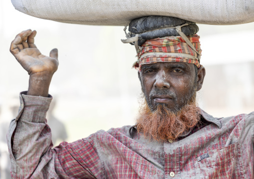 Bangladeshi porter carrying cement bag, Khulna Division, Abhaynagar, Bangladesh