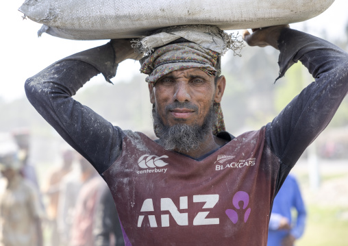 Bangladeshi porter carrying cement bag, Khulna Division, Abhaynagar, Bangladesh