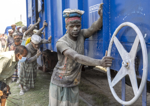 Bangladeshi workers pushing a blue train, Khulna Division, Abhaynagar, Bangladesh