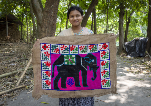 Bangladeshi young woman holding a hindu prayer rug depicting an elephant, Khulna Division, Narail Sadar, Bangladesh