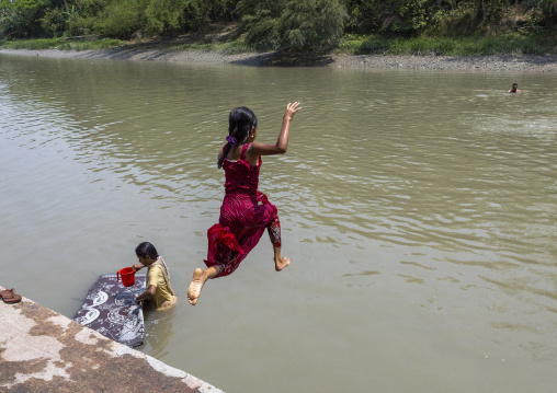 Bangladeshi girl jumping in the river in Sundarbans, Khulna Division, Narail Sadar, Bangladesh