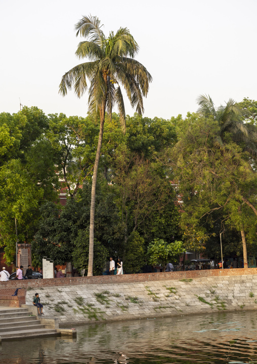 Bangladeshi people walking along a pond, Khulna Division, Jessore, Bangladesh