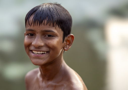 Portrait of smiling bangladeshi boy out of a pond, Khulna Division, Jessore, Bangladesh