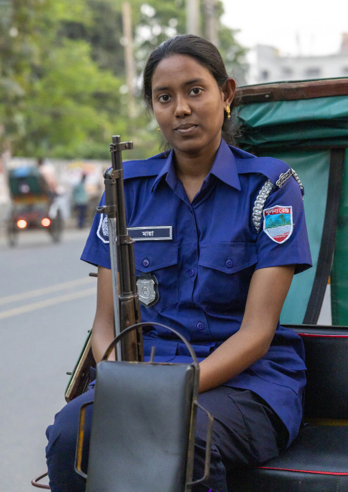 Portrait of a police woman with a gun, Khulna Division, Jessore, Bangladesh