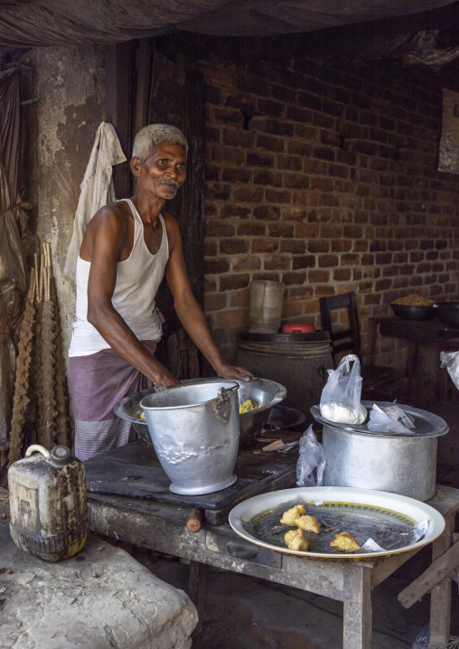 Bangladeshi old man cooking in a small restaurant, Rajshahi Division, Puthia, Bangladesh