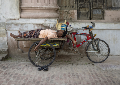 Bangladeshi man sleeping on a cart, Rajshahi Division, Puthia, Bangladesh