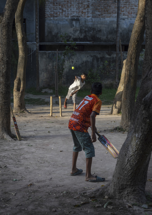 Bangladeshi boys playing cricket in the street, Rajshahi Division, Rajshahi, Bangladesh