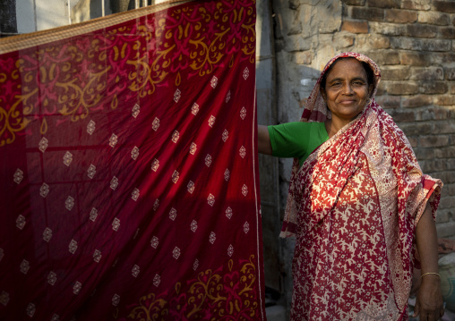 Portrait of a bangladeshi woman drying a sari, Rajshahi Division, Rajshahi, Bangladesh