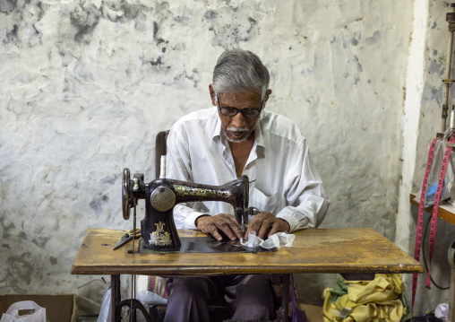 Bangladeshi man working on a sewing machine, Rajshahi Division, Rajshahi, Bangladesh