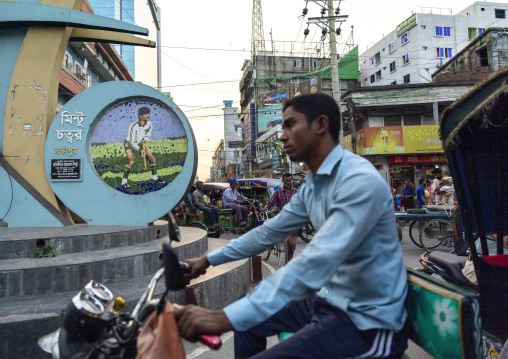 Bangladeshi man riding a rickshaw at a roundabout, Rajshahi Division, Rajshahi, Bangladesh