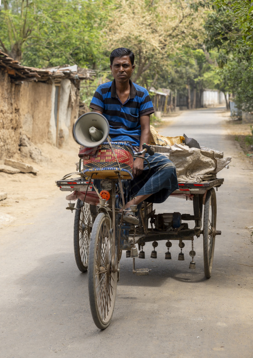 Bangladeshi seller riding a cart with a loudspeaker