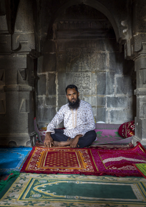 Bangladeshi muslim man sit inside Kusumba mosque, Naogaon District, Manda Upazila, Bangladesh