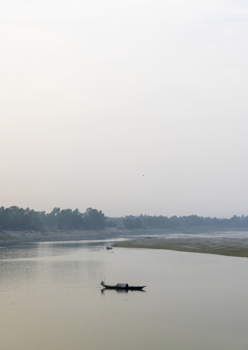 Local boat on a quiet river, Rajshahi Division, Sariakandi, Bangladesh