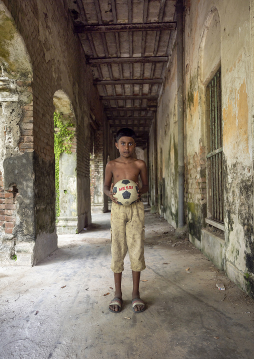 Bangladeshi boy with a Messi ball in Pakutia Zamindar Bari, Dhaka Division, Nagarpur, Bangladesh