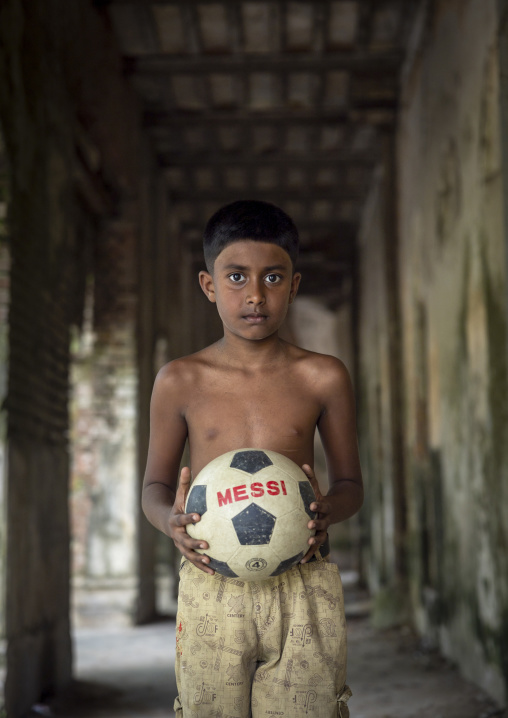 Bangladeshi boy with a Messi ball in Pakutia Zamindar Bari, Dhaka Division, Nagarpur, Bangladesh