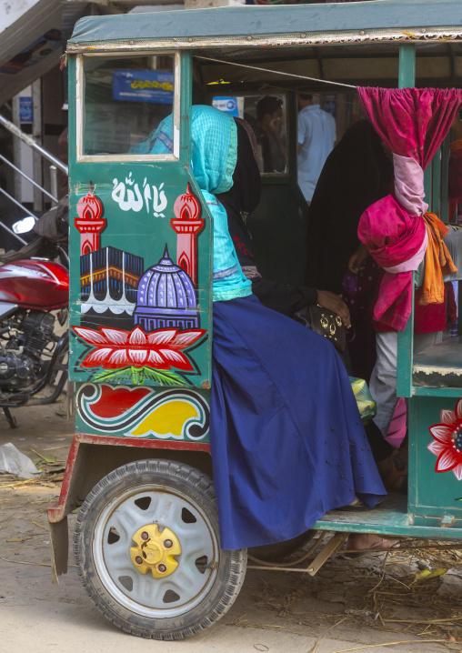 Bangladeshi woman in a rickshaw decorated with Mecca, Dhaka Division, Saturia, Bangladesh