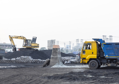 Excavator putting coal on trucks in Amin bazar, Dhaka Division, Sabhar, Bangladesh