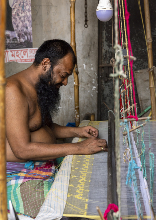 Bangladeshi man weaving in a small workshop, Dhaka Division, Rupganj, Bangladesh