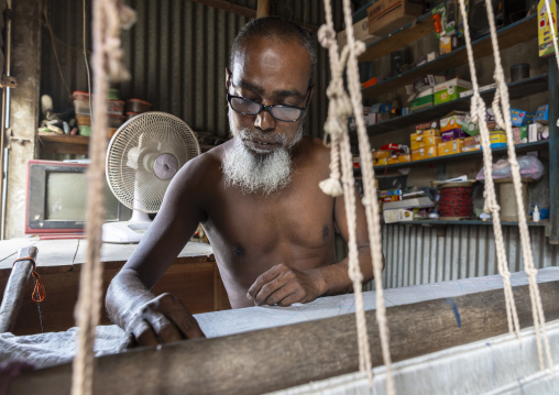 Bangladeshi man weaving in a small workshop, Dhaka Division, Rupganj, Bangladesh